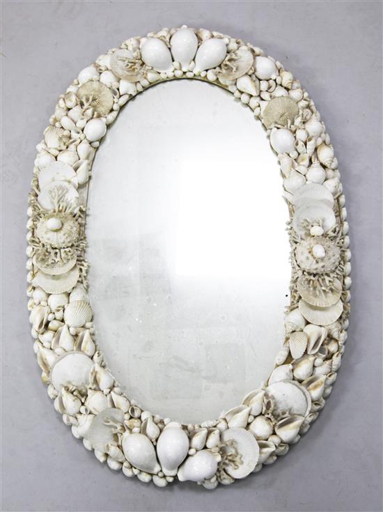 An ornate shellwork wall mirror, W.1ft 9in. H.2ft 6in.
